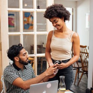 Lady charging a man with a card machine