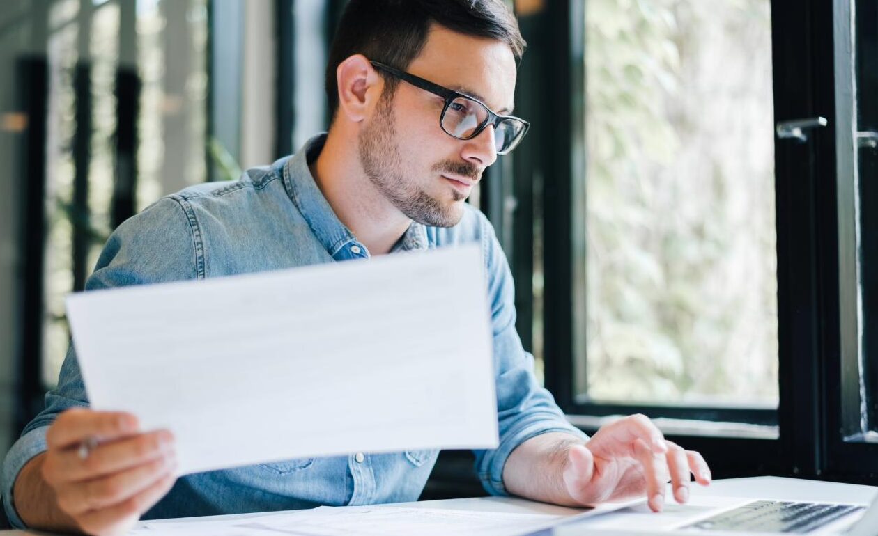 Man working on accounts on a laptop