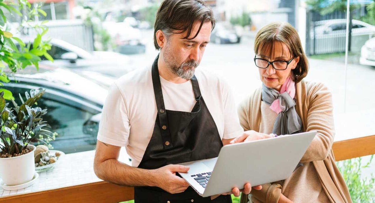 Business consultant advising small business cafe owner
